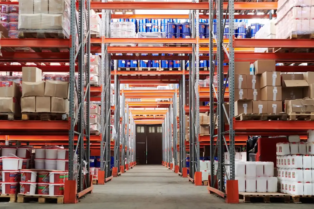 Wide angle view of a warehouse with stocked shelves and boxes