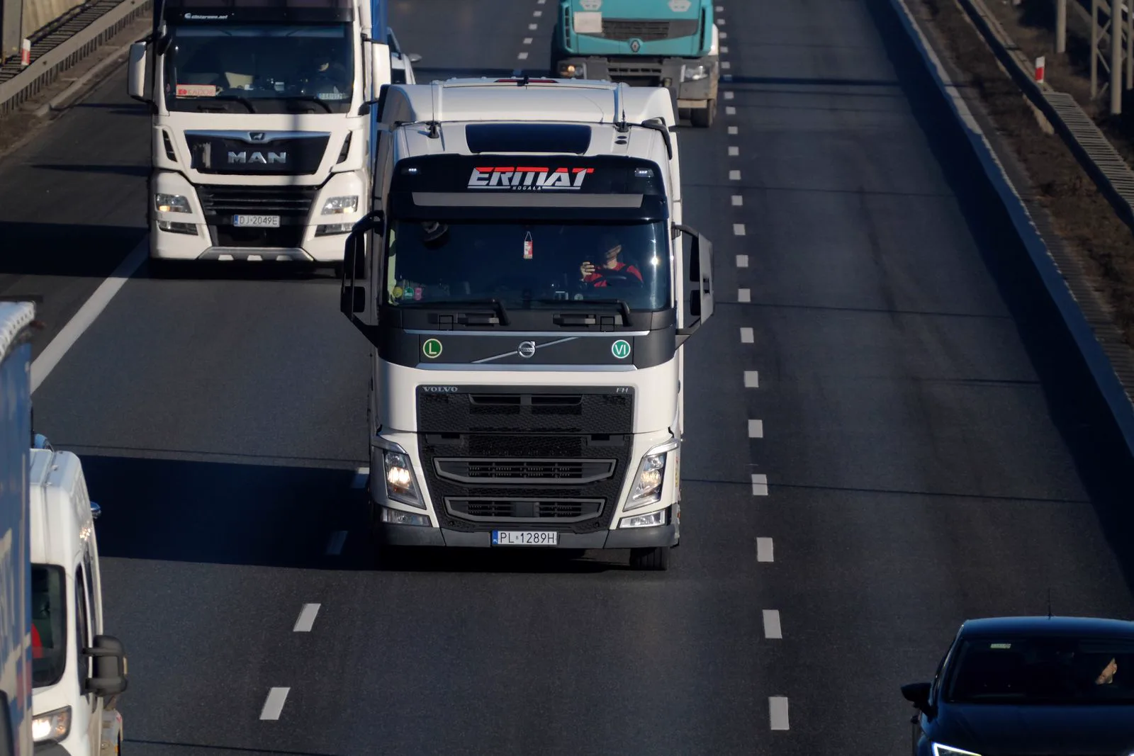 Heavy-duty freight trucks driving on a highway