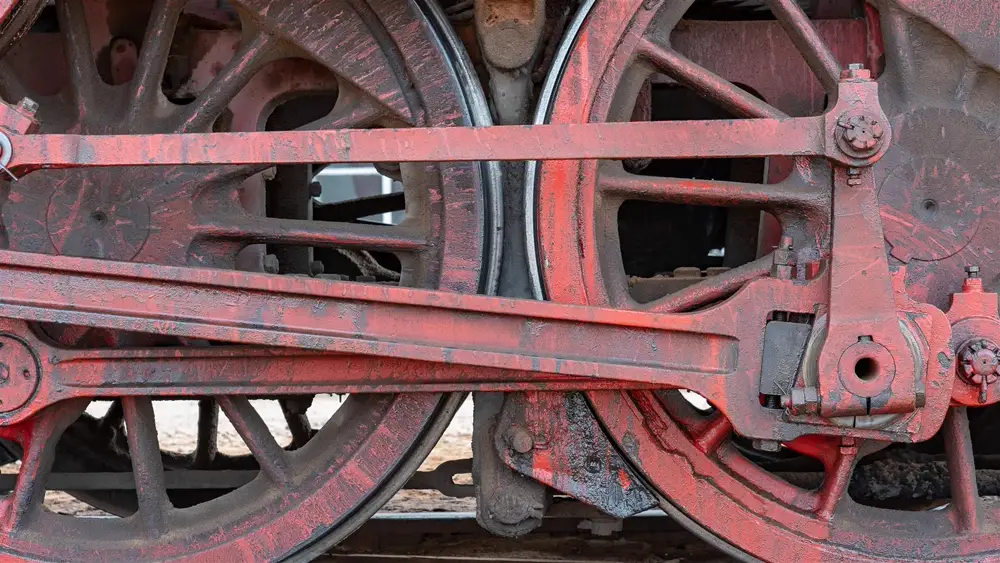 Close-up of vintage locomotive wheels and connecting rods