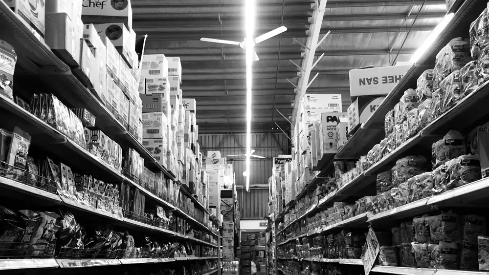 Supermarket aisle with shelves stocked with packaged products
